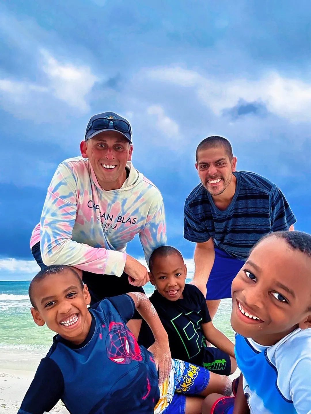 Josh and Kevin smiling together at the beach
